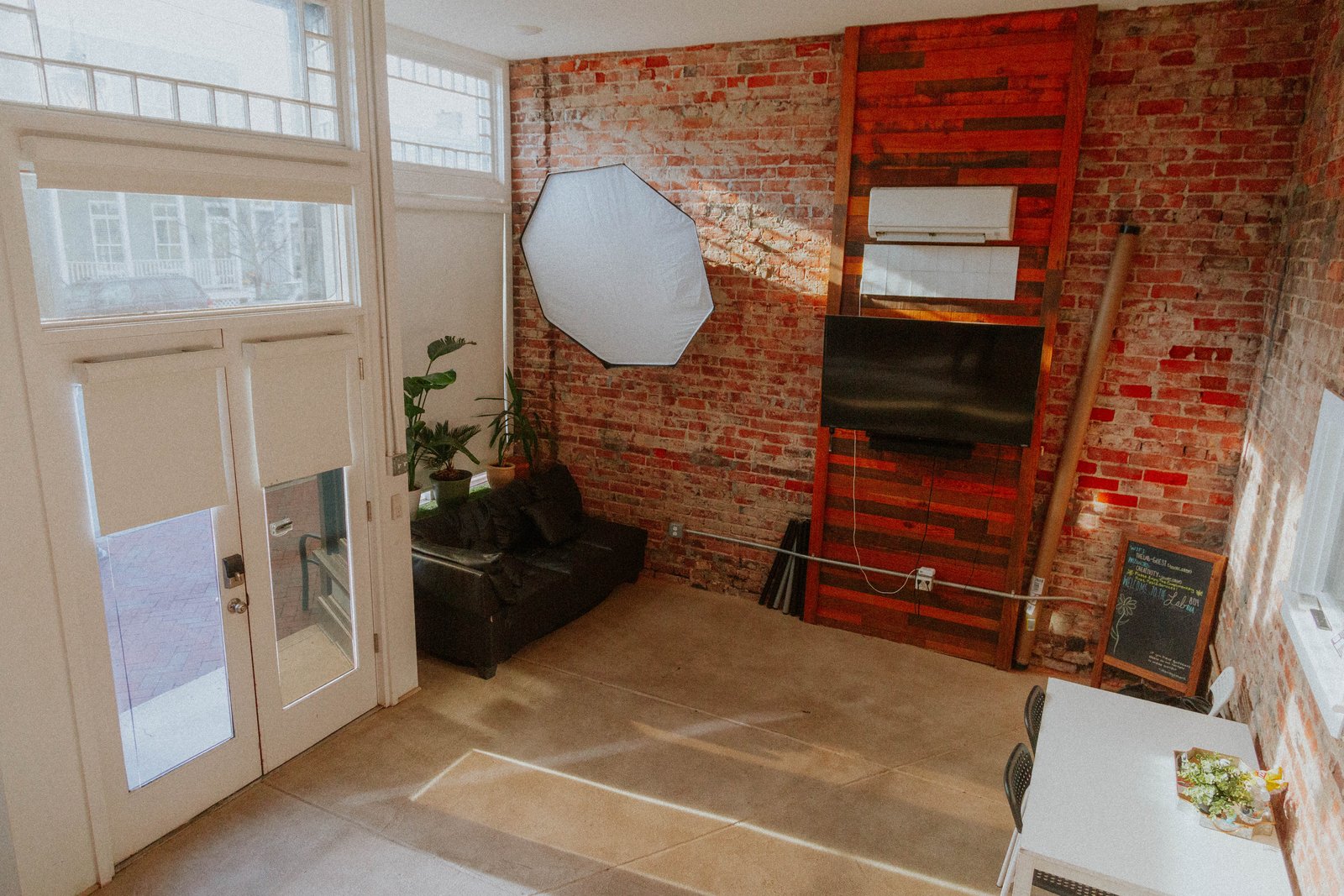 The lounge corner with the TV and a softbox