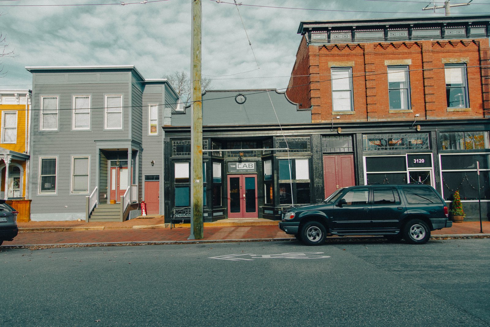 The storefront from across E Marshall St, with street parking out front