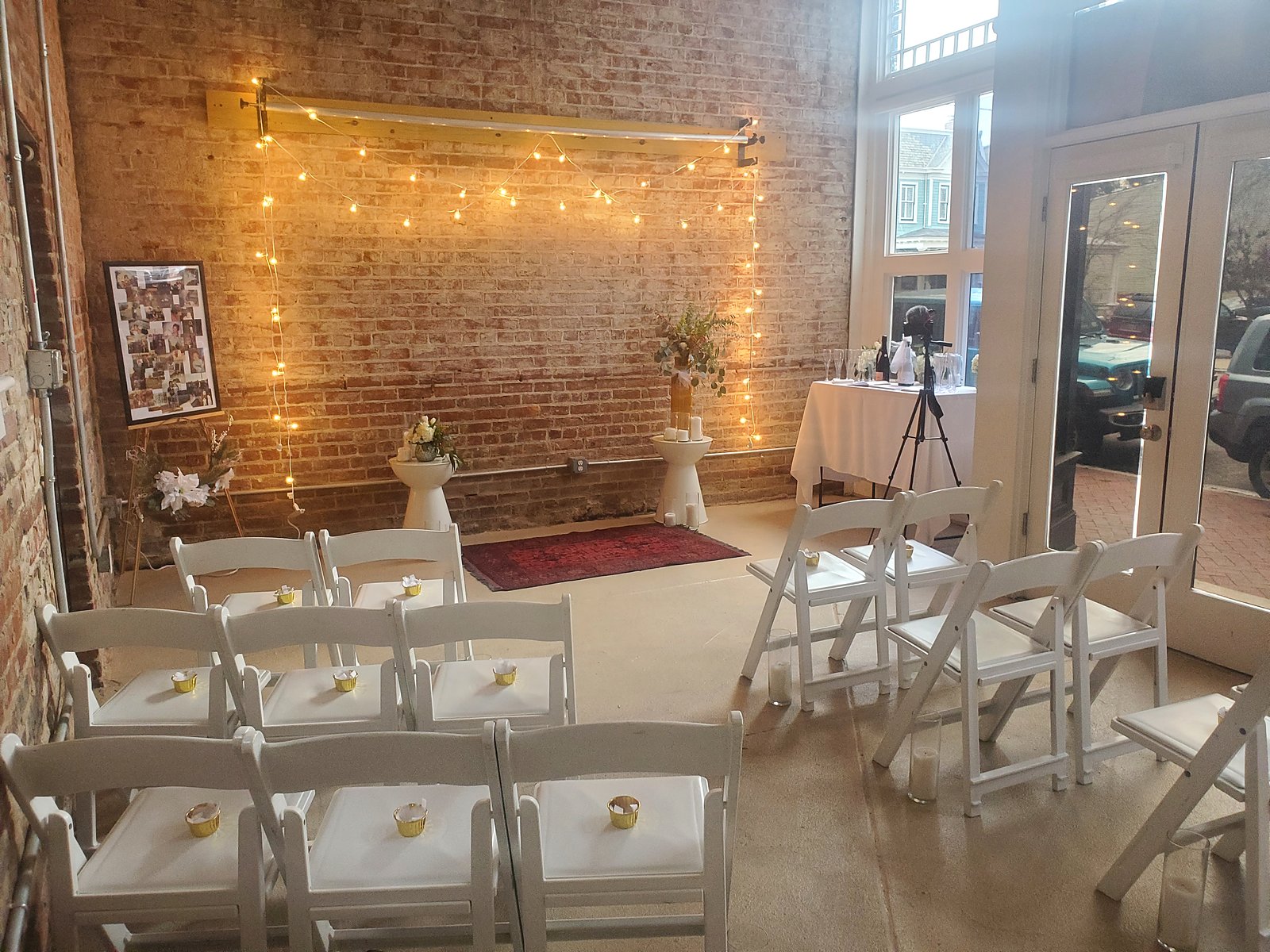 Seating for an intimate ceremony, facing the brick wall